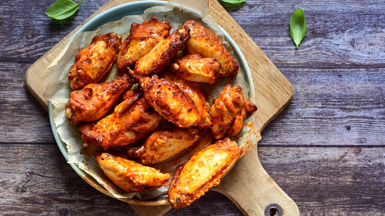 crispy fried chicken wings on wooden board