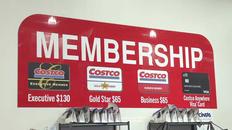A sign at Costco showing its various memberships and prices