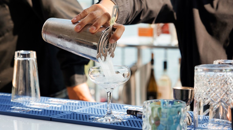 Bartender pouring drink at wedding