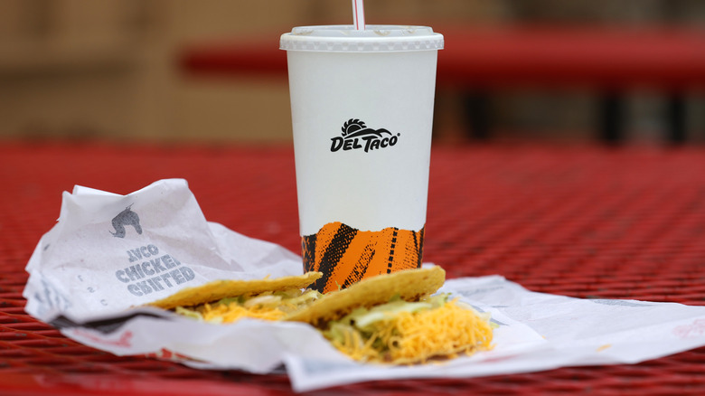 Del Taco tacos and soft drink cup