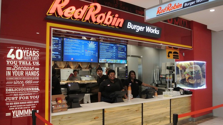 A small Red Robin Burger Works location with smiling employees behind counter