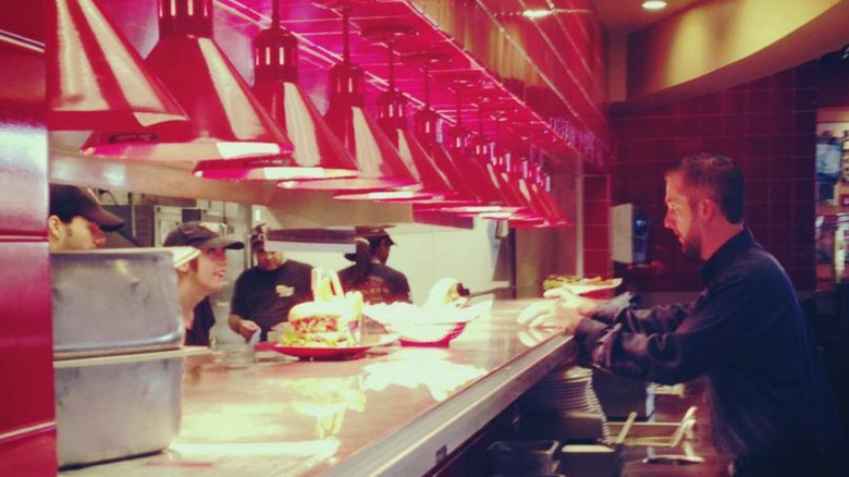 Server approaching expo line and kitchen at Red Robin