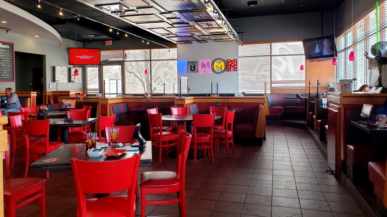 Empty Red Robin restaurant with brightly colored chairs and neon signs