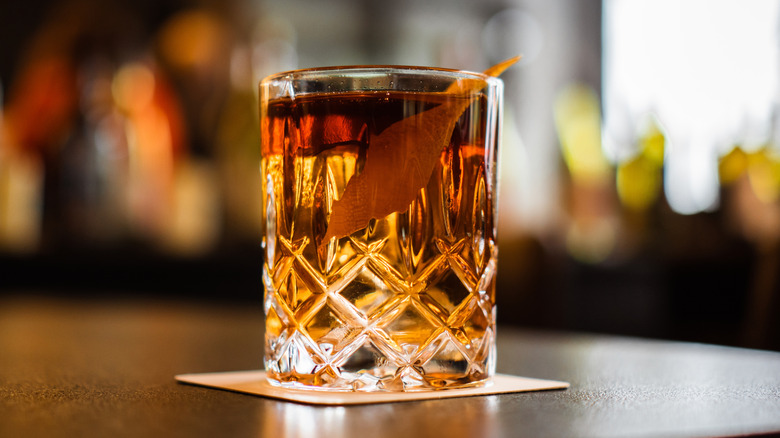a negroni on a coaster on a bar counter