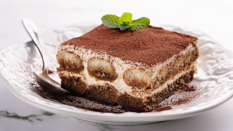 slice of tiramisu on a plate with a spoon