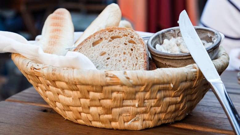 basket of bread and butter on a table