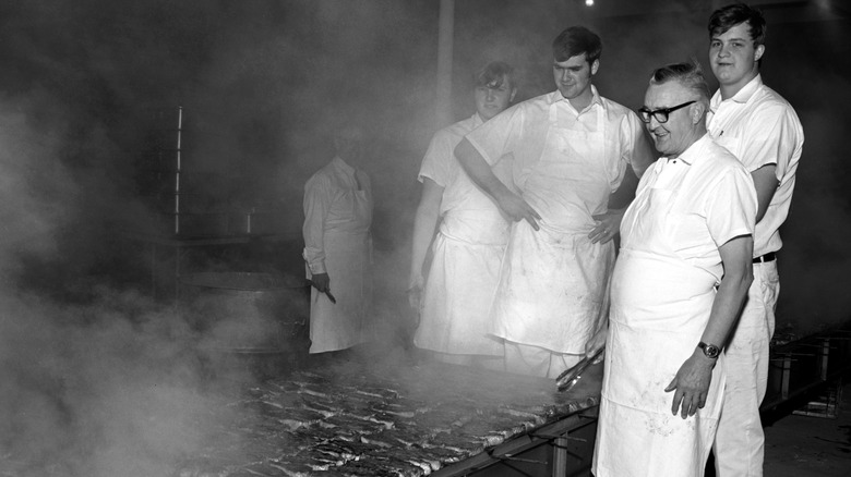 Men in front of a smoking pit, vintage