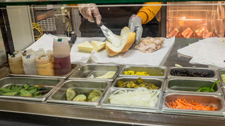 Deil employee making a sandwich