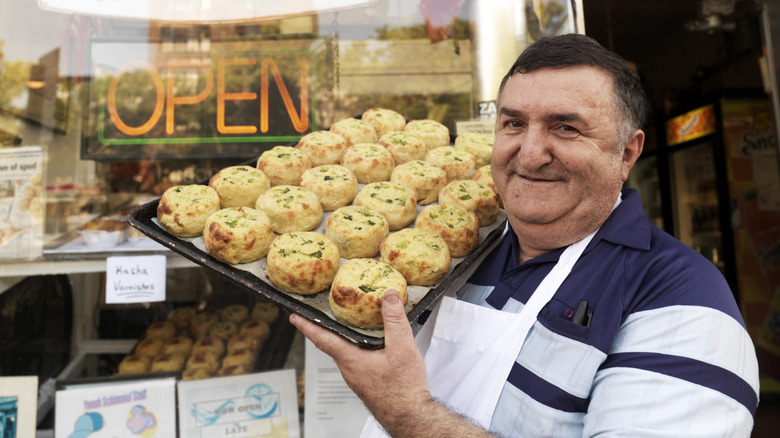 Deli owner holding knishes
