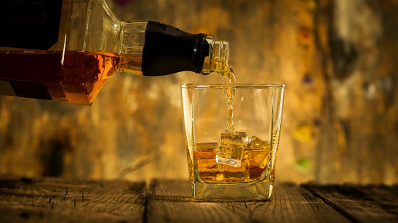 Pouring whiskey into glass