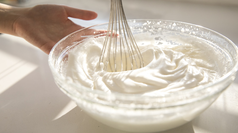 Whisking bowl of whipped cream