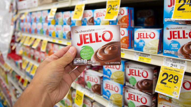 Person selecting pudding mix at store