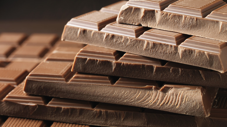 Several chocolate bars stacked on top of one another.