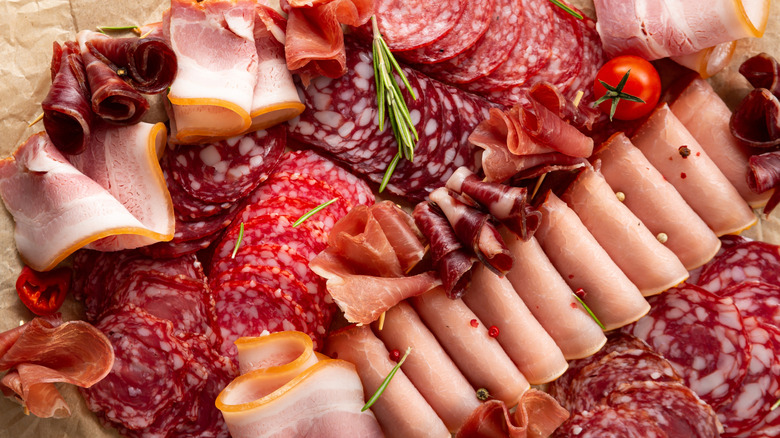 A plate of antipasto with herbs and cherry tomatoes