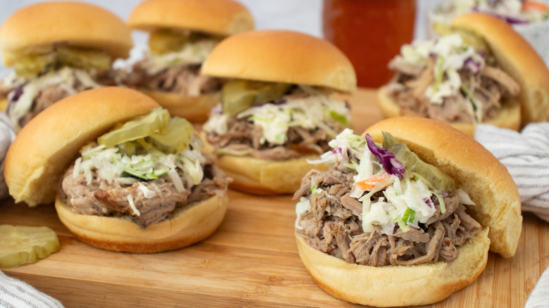 Side shot of several pulled pork sliders
