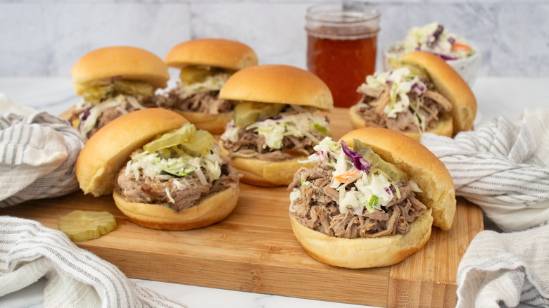 Side shot of several pulled pork sliders