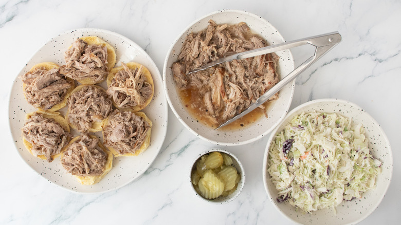 Slider roll bottoms topped with pulled pork