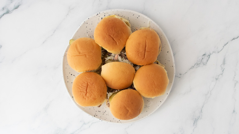 Pulled pork sliders on a large white plate