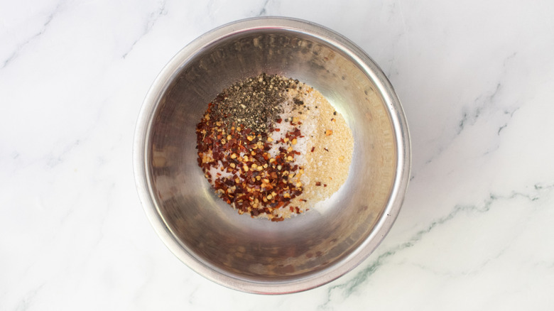 Assorted seasonings in a metal bowl
