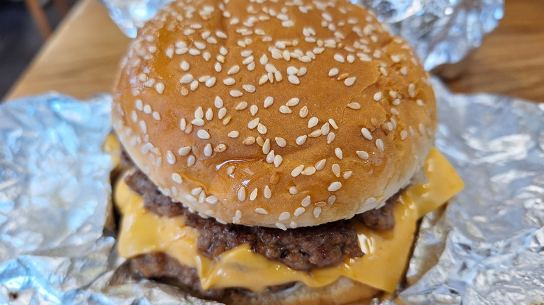 A close-up of a regular cheeseburger from Five Guys