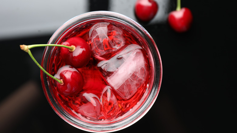 Top view of drink with ice cubes and cherries