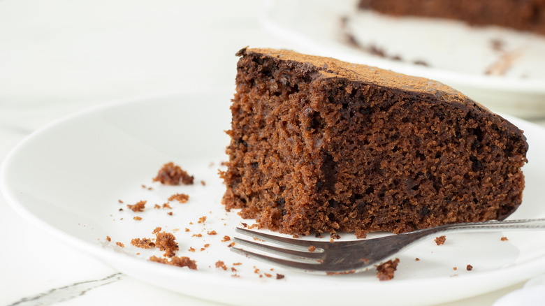 Vegan chocolate cake slice on a white plate