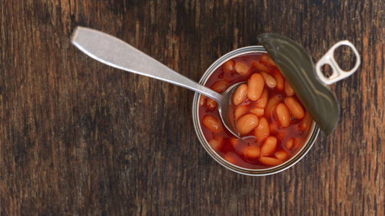 Spoon in an open can of beans