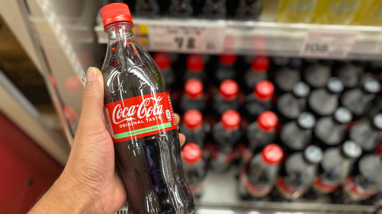 Person holding a Japanese bottle of Coca-Cola