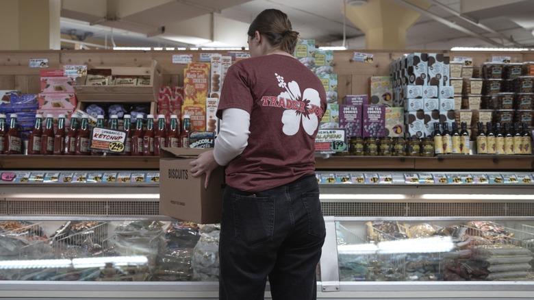 A Trader Joe's employee stocking the shelves.