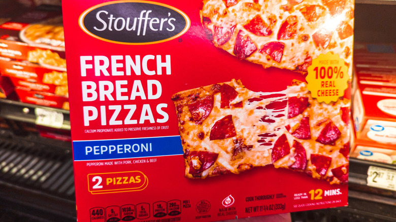 A box of the Stouffer's French Bread Pizzas inside of a grocery store.
