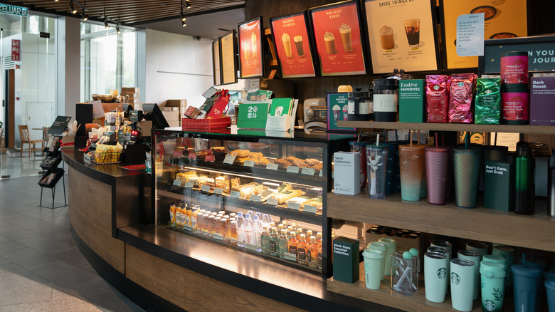 The interior of a Starbucks location with baked goods and merchandise.