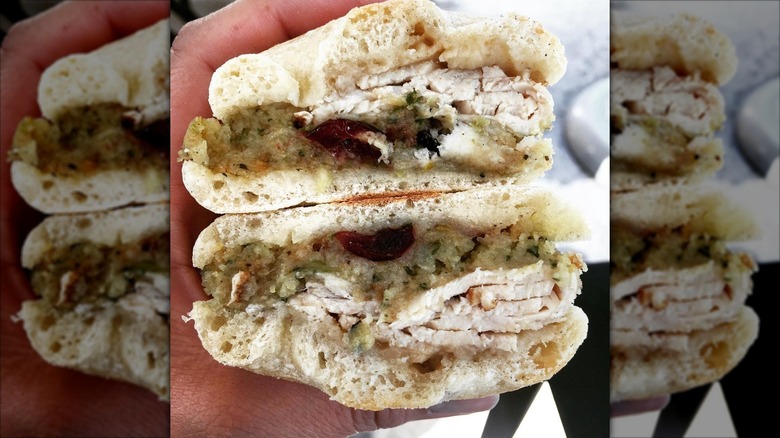 Hand holding Starbucks holiday turkey panini