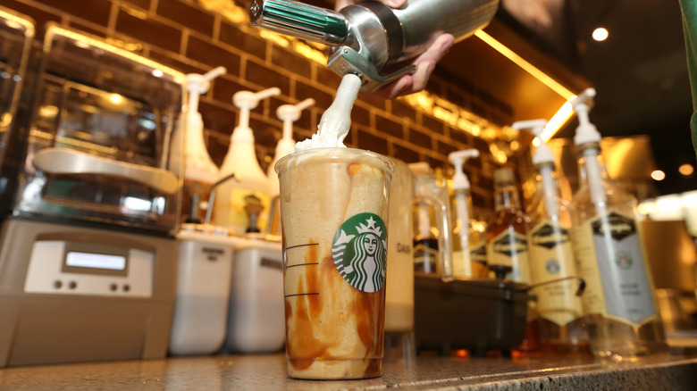Whipped cream applied to Starbucks drink