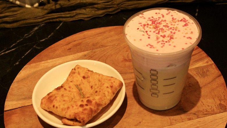 Starbucks Iced Cherry Chai beside a Chicken Jalapeño Pocket