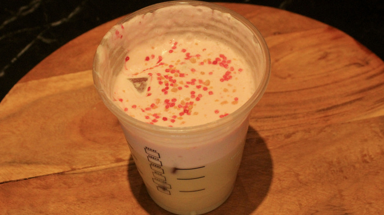 Partially drunk Starbucks iced latte with cold foam and sprinkles