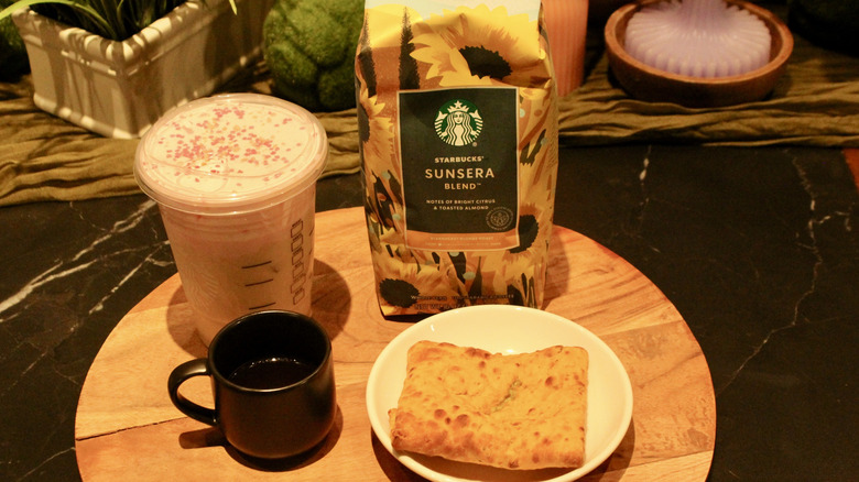Starbucks coffee bag, iced latte, and flatbread snack