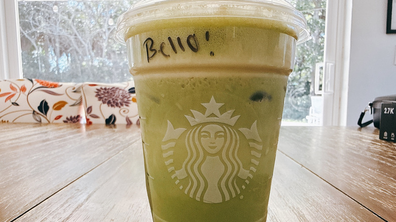 Starbucks Grande Iced Banana Bread Matcha on a wooden table