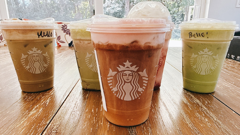 Five Starbucks Valentine's Menu drinks on a wooden table