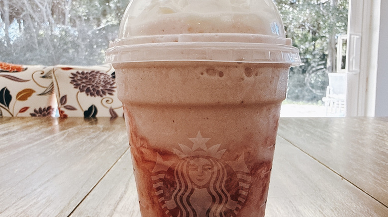 Starbucks Grande Strawberry Shortcake Frappuccino on wooden table