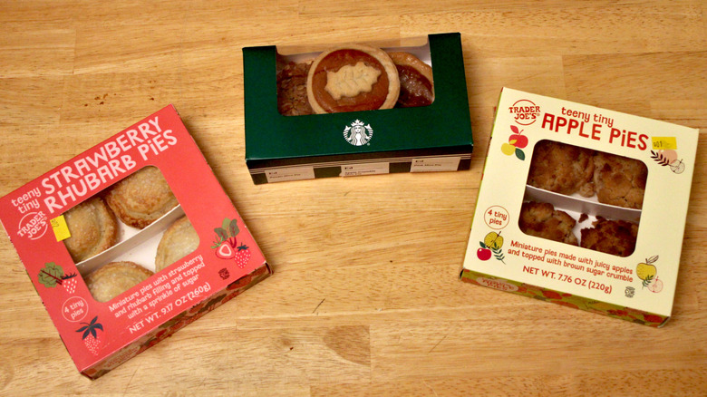 An assortment of Starbucks and Trader Joe's mini pies in boxes