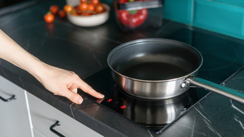 A pan pre-heating on an electric stove top