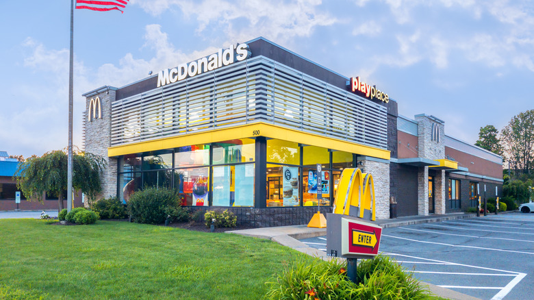 modern architecture mcdonalds restaurant with american flag flying beside it
