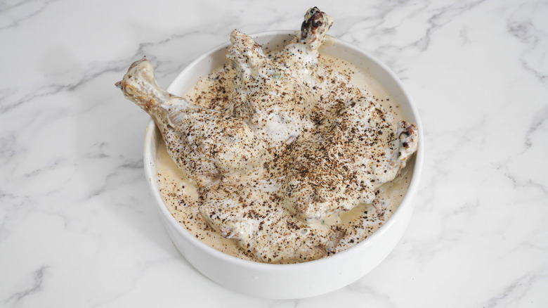 Chicken marinating in yogurt with spices