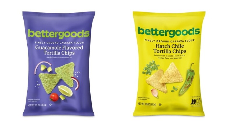 Two bags of ﻿Bettergoods Finely Ground Cassava Flour Tortilla Chips, one guacamole-flavored and the other Hatch chile-flavored, on white background