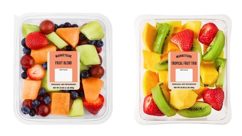 Two clear plastic tubs, one containing the Marketside Seasonal Fruit Blend and the other the Marketside Tropical Fruit Trio, on a white background