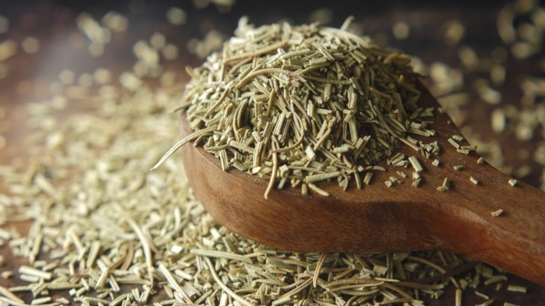 A measuring spoon full of rosemary.