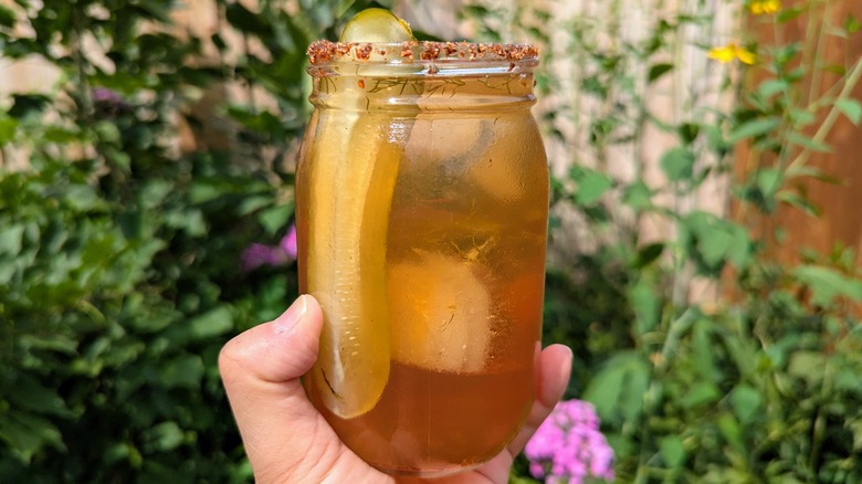 hand holding pickle iced tea