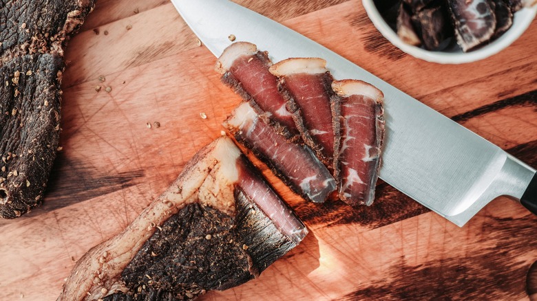 Pieces of beef jerky on a wooden cutting board