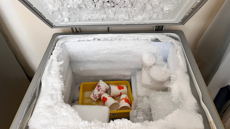 Overhead view of a open and over-frosted freezer chest