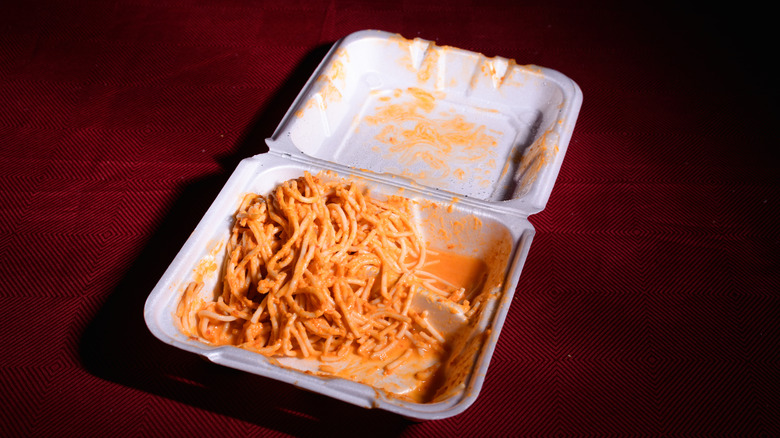 Leftover spaghetti with red sauce in a takeout box